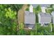 Aerial shot of backyard featuring a deck, patio, fire pit, and creek running along the property at 10304 Ebbets Rd, Charlotte, NC 28273