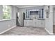 Elegant bar area boasts custom cabinetry, stylish backsplash, and stainless steel refrigerator at 10304 Ebbets Rd, Charlotte, NC 28273