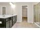 Bathroom featuring a double sink vanity, walk-in closet, and glass-enclosed shower at 10304 Ebbets Rd, Charlotte, NC 28273