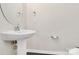 Bathroom with pedestal sink, wood-look floors, and toilet at 10304 Ebbets Rd, Charlotte, NC 28273