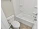Bathroom featuring a toilet and bathtub with white tile surround at 10304 Ebbets Rd, Charlotte, NC 28273