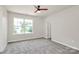 Bedroom with carpet, a ceiling fan, and a window providing natural light at 10304 Ebbets Rd, Charlotte, NC 28273