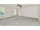 Bedroom with carpeting, two windows, and overhead fan with light fixture at 10304 Ebbets Rd, Charlotte, NC 28273