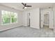 Bedroom featuring neutral walls, carpet, a ceiling fan, and natural light from the window at 10304 Ebbets Rd, Charlotte, NC 28273