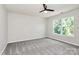 Bedroom with carpet, a ceiling fan, and a large window for natural light at 10304 Ebbets Rd, Charlotte, NC 28273