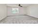 Large bedroom with carpeting and a window at 10304 Ebbets Rd, Charlotte, NC 28273