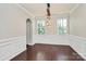 Dining room with hardwood floors, wainscoting, and a modern chandelier at 10304 Ebbets Rd, Charlotte, NC 28273