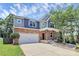 Charming two-story home featuring a stone facade, a front porch, and a two-car garage at 10304 Ebbets Rd, Charlotte, NC 28273