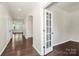 Open hallway with hardwood flooring and arched doorways leading to various rooms at 10304 Ebbets Rd, Charlotte, NC 28273