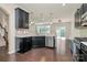 Modern kitchen with stainless steel appliances, black cabinetry, and a view into the dining area at 10304 Ebbets Rd, Charlotte, NC 28273