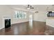 Bright open concept living space with hardwood floors and a fireplace at 10304 Ebbets Rd, Charlotte, NC 28273