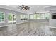 Expansive living room with gray wood floors and abundant natural light at 10304 Ebbets Rd, Charlotte, NC 28273