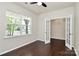 Home office with hardwood floors, a large window, and glass paneled doors at 10304 Ebbets Rd, Charlotte, NC 28273