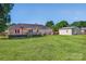 Large backyard presents a manicured lawn, deck for entertaining, and a detached garage at 106 Abbey Cir, Salisbury, NC 28147