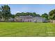 Expansive backyard showcases a well-maintained lawn, deck, and detached garage at 106 Abbey Cir, Salisbury, NC 28147