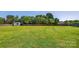 Expansive backyard featuring a lush green lawn, shed, and privacy fence, perfect for recreation and relaxation at 106 Abbey Cir, Salisbury, NC 28147