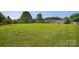 Vast backyard with mature trees and privacy fence, offering ample space for outdoor activities and entertaining at 106 Abbey Cir, Salisbury, NC 28147