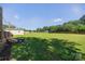 Large grassy backyard featuring mature trees and outdoor storage at 106 Abbey Cir, Salisbury, NC 28147
