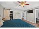 This bedroom features a barn-door closet, tray ceiling, and an inviting blue quilt at 106 Abbey Cir, Salisbury, NC 28147