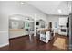 Open floor plan showcasing kitchen with island and adjacent living room with hardwood floors at 106 Abbey Cir, Salisbury, NC 28147