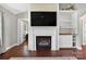 Cozy living room featuring a fireplace with a TV above and a built-in bookshelf at 106 Abbey Cir, Salisbury, NC 28147