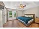 Main bedroom with wood flooring, a ceiling fan, and French doors leading to the deck at 106 Abbey Cir, Salisbury, NC 28147