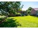 Well-manicured lawn, patio area, and black metal fence surrounding this backyard at 1083 Fox Chase Dr, Newton, NC 28658