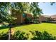 Lush green lawn with a brick home, a covered patio, and a black metal fence at 1083 Fox Chase Dr, Newton, NC 28658