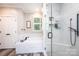 Clean bathroom featuring a soaking tub, tiled surround, and separate glass enclosed shower at 1083 Fox Chase Dr, Newton, NC 28658