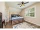 Bright bedroom with a wooden bed frame, large window with shutters and a textured rug at 1083 Fox Chase Dr, Newton, NC 28658