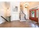 Inviting foyer with hardwood floors, staircase, and decorative lighting at 1083 Fox Chase Dr, Newton, NC 28658