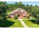Charming brick home with a manicured lawn and lush landscaping at 1083 Fox Chase Dr, Newton, NC 28658
