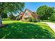 Beautiful home with a manicured lawn, mature trees, and a brick facade at 1083 Fox Chase Dr, Newton, NC 28658