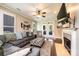 Inviting living room featuring a fireplace, large tv, and stylish gray sectional sofa at 1083 Fox Chase Dr, Newton, NC 28658