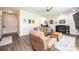 Cozy living room with hardwood floors, brick fireplace, and comfortable furniture at 1083 Fox Chase Dr, Newton, NC 28658