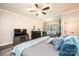Cozy main bedroom with a ceiling fan, large windows, and a sitting area with two chairs at 1083 Fox Chase Dr, Newton, NC 28658