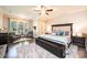 Spacious main bedroom with a ceiling fan, large windows, and a sitting area with two chairs at 1083 Fox Chase Dr, Newton, NC 28658