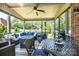 Inviting covered patio featuring comfortable seating, ceiling fan, and views of the lush backyard at 1083 Fox Chase Dr, Newton, NC 28658