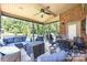 Relaxing screened porch with comfortable seating, ceiling fan, and privacy at 1083 Fox Chase Dr, Newton, NC 28658