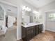 Well-lit bathroom featuring a double sink vanity, tile flooring, and a glass-enclosed shower at 117 Autumn Mist Rd, Statesville, NC 28677