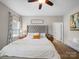 Bright bedroom features a plush bed with a tufted headboard, neutral tones, and a cozy atmosphere at 117 Autumn Mist Rd, Statesville, NC 28677