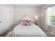 Inviting bedroom with a cozy bed, plush pillows, and natural light from the window at 117 Autumn Mist Rd, Statesville, NC 28677