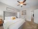 Bright bedroom features a plush bed with a tufted headboard, neutral tones, and a cozy atmosphere at 117 Autumn Mist Rd, Statesville, NC 28677