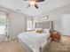 Bright bedroom features a plush bed with a tufted headboard, neutral tones, and a cozy atmosphere at 117 Autumn Mist Rd, Statesville, NC 28677