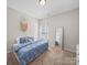 Bright bedroom featuring a cozy bed with a blue comforter and a full-length mirror at 117 Autumn Mist Rd, Statesville, NC 28677