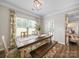 Inviting dining room with an rustic wooden table, bench seating, and lovely natural light at 117 Autumn Mist Rd, Statesville, NC 28677