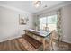 Inviting dining room with an rustic wooden table, bench seating, and lovely natural light at 117 Autumn Mist Rd, Statesville, NC 28677