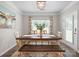Inviting dining room with an rustic wooden table, bench seating, and lovely natural light at 117 Autumn Mist Rd, Statesville, NC 28677