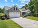 Charming house with stone and siding exterior, well-kept lawn, and a spacious driveway at 117 Autumn Mist Rd, Statesville, NC 28677