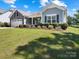 Attractive home showcasing a blend of stone and siding, enhanced by mature landscaping at 117 Autumn Mist Rd, Statesville, NC 28677